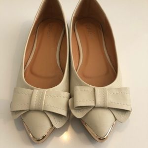 Tan ballerina flats with gold detailing